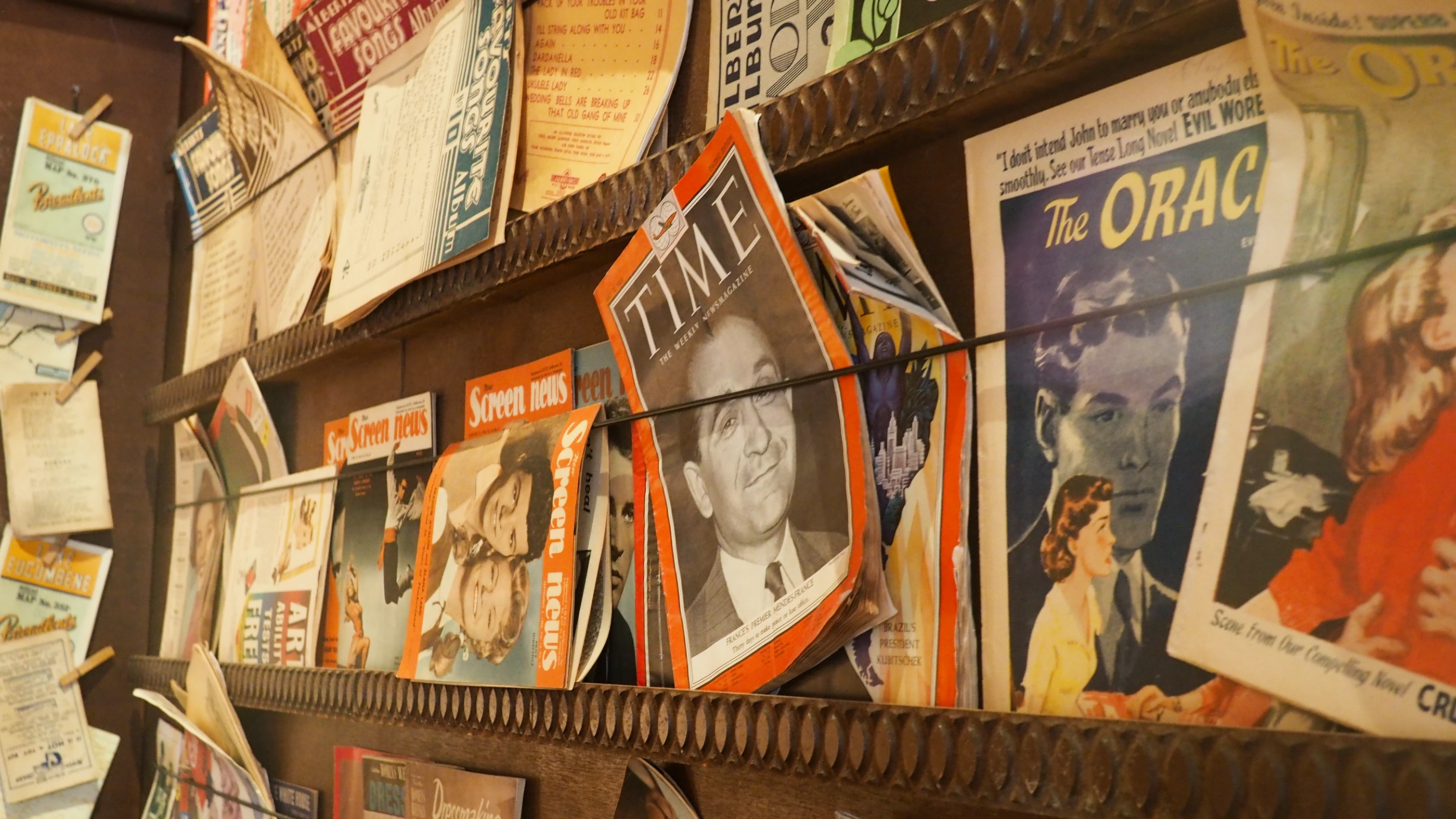 Old magazines lined up on a vintage display cabinet
