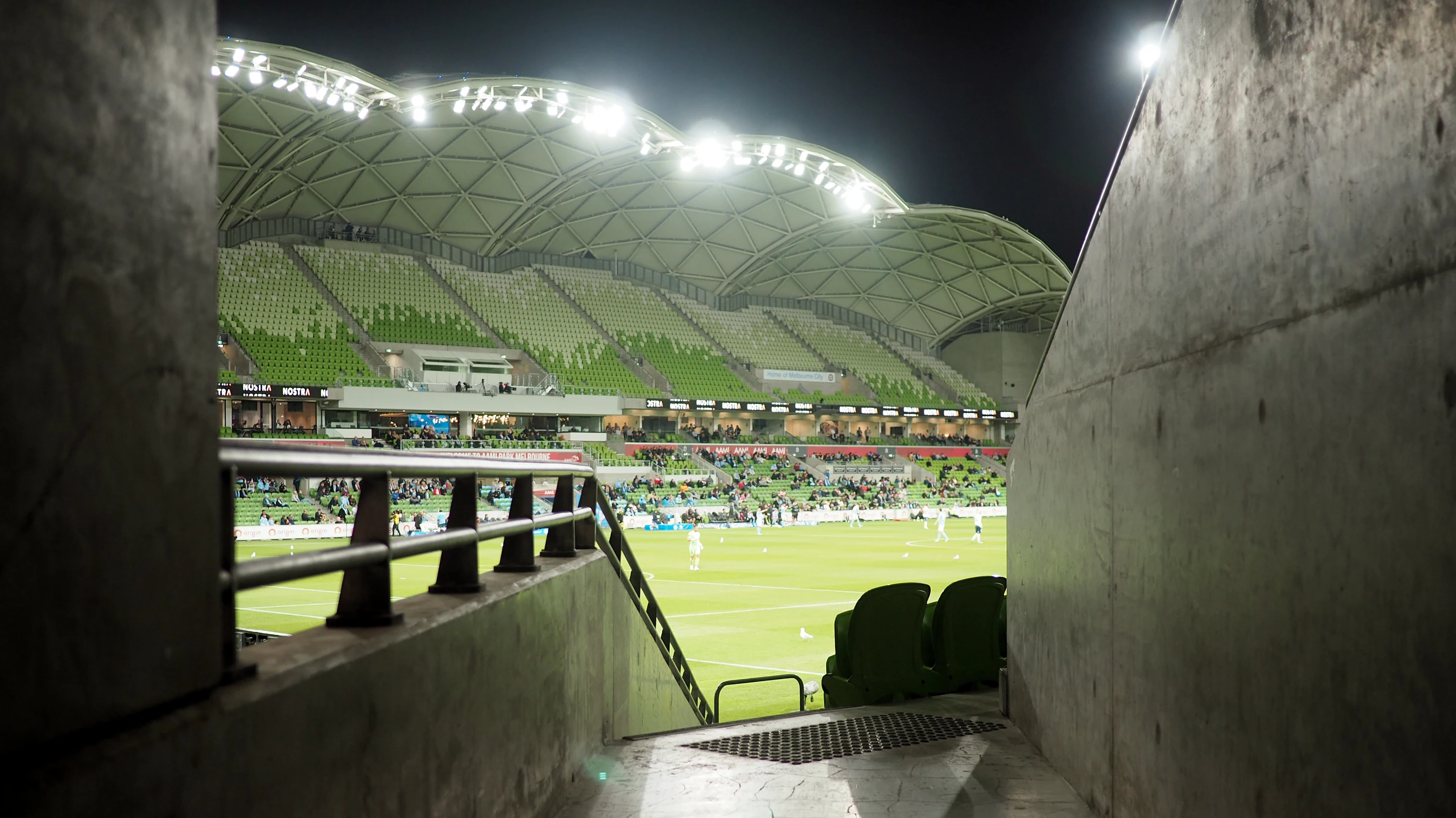 A view through one of the entry gates into an almost empty AAMI Park at night.